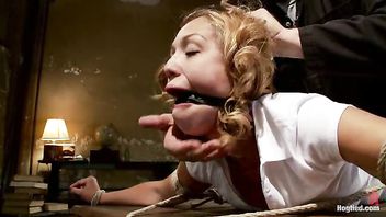 A hot beauty bound over a table for orgasms and punishments